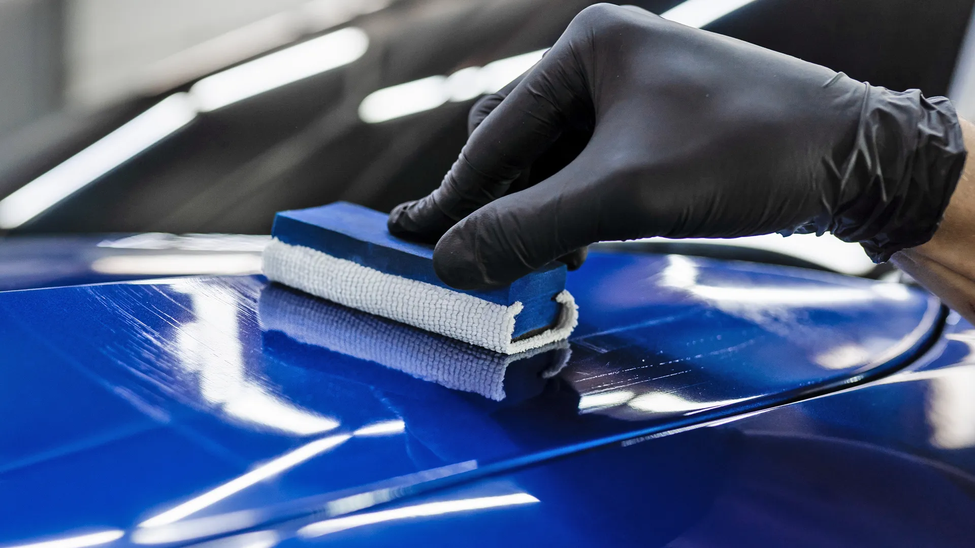 Professional ceramic coating being hand-applied to a vehicle
