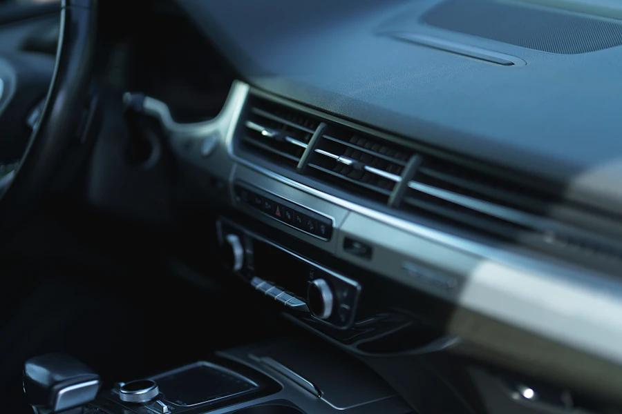 Car interior dashboard and AC vent detail showing cabin plastic trim panels